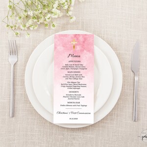 May include: Pink and gold first communion menu with a cross at the top. The menu lists appetizers, main dishes, desserts, and a mimosa bar. The text at the bottom reads "Christina's First Communion 05.12.2023".