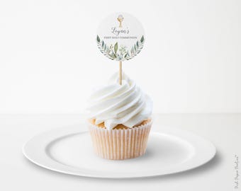 May include: White cupcake with white frosting topped with a round, white and green paper cupcake topper that says "Logan's First Holy Communion" with a small white chalice icon.