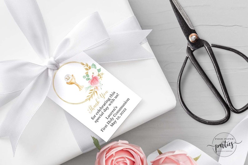 May include: White thank you tag with gold trim and floral design. The tag features a gold chalice with a host and the text "Thank You for celebrating this special day with us! Lauren's First Holy Communion May 12, 2022".