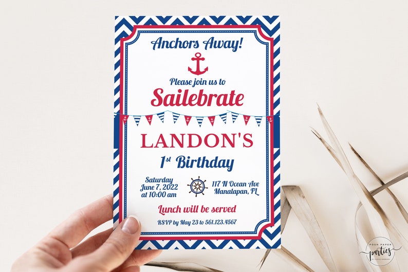 May include: A blue and red nautical themed birthday invitation for Landon's 1st birthday. The invitation features an anchor, a ship's wheel, and a string of red, white, and blue pennants. The text reads "Anchors Away! Please join us to Sailebrate LANDON'S 1st Birthday. Saturday June 7, 2022 at 10:00 am 117 N Ocean Ave Manalapan, FL Lunch will be served RSVP by May 23 to 561.123.4567"