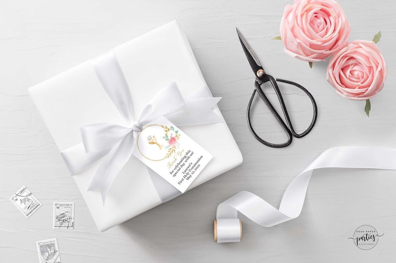 May include: White gift box with a white satin ribbon tied in a bow. A white gift tag with gold trim and a floral design is attached to the ribbon. The tag says "Thank You for celebrating this special day with me.  [Name]'s First Holy Communion May 18, 2019".