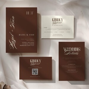 May include: A set of wedding stationery in deep brown and cream, including an invitation with the text Hazel + Finn, a cream RSVP card, a brown RSVP card with a QR code, and a wedding details card, all featuring elegant serif and script typography.
