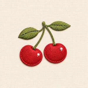 May include: An embroidered patch featuring two bright red cherries with green stems and leaves. Each cherry has a small white dot to represent a highlight, and the entire design is stitched onto a plain, light beige fabric background.