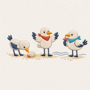 May include: Embroidered design featuring three cartoon seagulls on a sandy beach. One seagull examines a seashell, another has its wings spread, and the third holds a starfish. Each bird wears a colorful scarf. The design includes small waves.