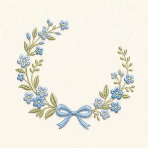 May include: Embroidered floral wreath featuring light blue flowers, green leaves, and a light blue bow. The design is set against a cream-colored background. The flowers have yellow centers. The embroidery is detailed and delicate, creating a classic, elegant look.
