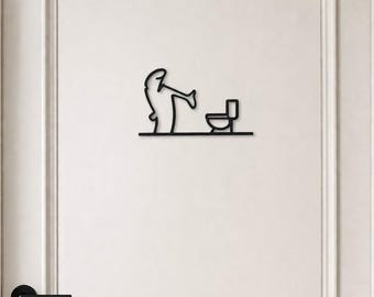 May include: Black metal wall art depicting a person using a toilet. The minimalist design features a simple outline of a figure and a toilet, mounted on a white door. The door has a black handle and a white frame.