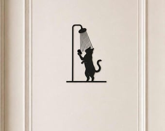 May include: A black metal wall decal featuring a silhouette of a cat standing on its hind legs under a shower head. The cat is holding a small sponge in its front paws while water lines extend from the shower head down toward the cat's head.