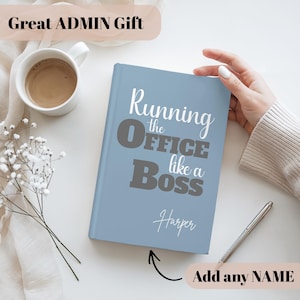 May include: A light blue notebook with the text "Running the Office like a Boss" in white and gray. The name "Harper" is written below the text. A coffee mug, pen, and flowers are also in the image. The text "Great ADMIN Gift" is at the top.