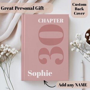 May include: A dusty rose hardcover book featuring the white text CHAPTER and the large number 30 centred on the front cover. The name Sophie is printed in white at the bottom. The cover includes a custom back cover option as noted in the text.