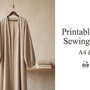 Peut inclure: Une abaya beige est suspendue à un cintre en bois. Le vêtement à manches longues a un design ample et fluide. L'image comprend le texte "Printable Abaya Sewing Pattern A4 & A0".
