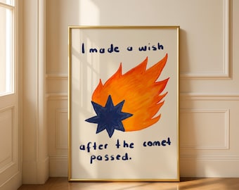 May include: Framed art print featuring a whimsical illustration of a comet with a dark blue star and orange flames. The text reads, "I made a wish after the comet passed."