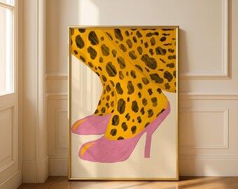 May include: A framed art print featuring a stylized illustration of legs in yellow leopard print tights and pink high heels. The artwork is set against a neutral background, with a gold frame.
