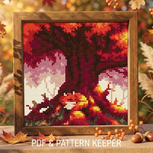 May include: Cross-stitch picture in a wooden frame. The image shows an autumn scene with a tree, leaves, and a fox. The colour palette includes shades of red, orange, brown, and white. Text at the bottom reads "PDF & PATTERN KEEPER."