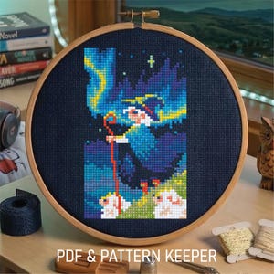 May include: A cross-stitch embroidery in a wooden hoop features a whimsical design of a figure with a staff, set against a backdrop of blue and yellow aurora borealis. The text "PDF & PATTERN KEEPER" is at the bottom.
