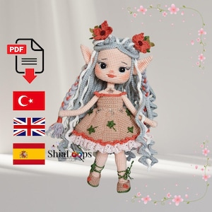 May include: A handmade crochet doll with long gray braids, pointed ears, and a floral headpiece. The doll wears a tan dress with green leaf accents and a red trim. The doll's shoes are green with matching laces. The image includes the text "ShiaLoops".
