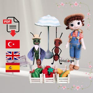 May include: Crocheted dolls and produce, including a boy doll in overalls, two insect dolls, and miniature produce in wooden crates. The dolls are wearing hats and clothing. A crocheted umbrella and a bench are also present.