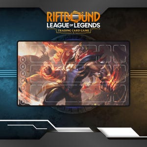May include: A rectangular Riftbound League of Legends trading card game playmat. The mat features a detailed illustration of a character with fiery elements. The top of the mat has the game's logo. The mat has numbered zones for gameplay.