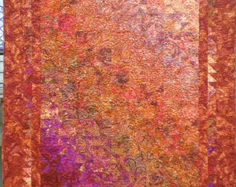 Lap Quilt With the Pinwheeel Block and Gradation in Warm Colored Batiks