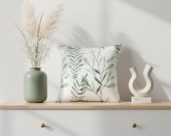 Almofada decorativa verde-sálvia com capa removível em aquarela.