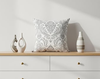 Almofada decorativa cinza damasco com capa removível.