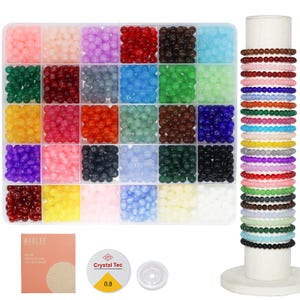 May include: A bead kit with a variety of colorful beads in a clear divided container. The beads are arranged by color, including pink, purple, red, black, blue, green, yellow, and orange. Several beaded bracelets are displayed on a white stand, along with string and other crafting supplies.