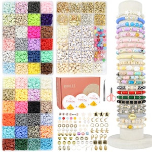 May include: A jewelry-making kit with various colorful beads, charms, and tools. The kit includes a box of flat polymer clay beads in multiple colors, gold-colored metal charms, and a selection of bracelets on a display stand. The kit also includes the text "WOOLEE".