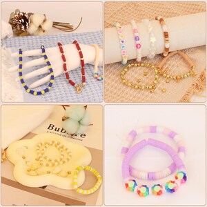 May include: A collection of handmade bracelets and necklaces in various styles and colors. The jewelry includes beaded necklaces in blue and red, and bracelets with colorful beads, stars, and flower accents. Some bracelets are gold, and others are made of clay.