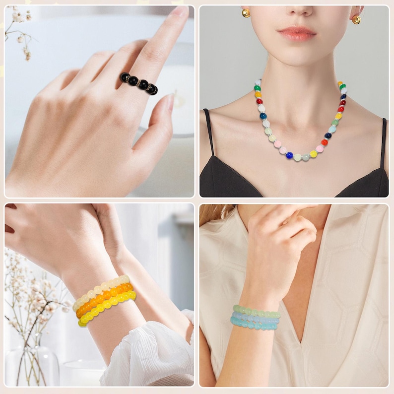 May include: A collection of colorful beaded jewelry. Includes a black ring with four beads, a multi-colored beaded necklace, and two beaded bracelets in yellow-orange and blue-green hues. The jewelry is displayed on a person.