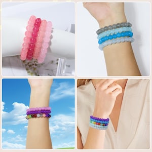 May include: A collection of beaded bracelets in various colors, including pink, purple, blue, and a rainbow assortment. The bracelets are shown stacked on wrists, showcasing the different color combinations and styles.