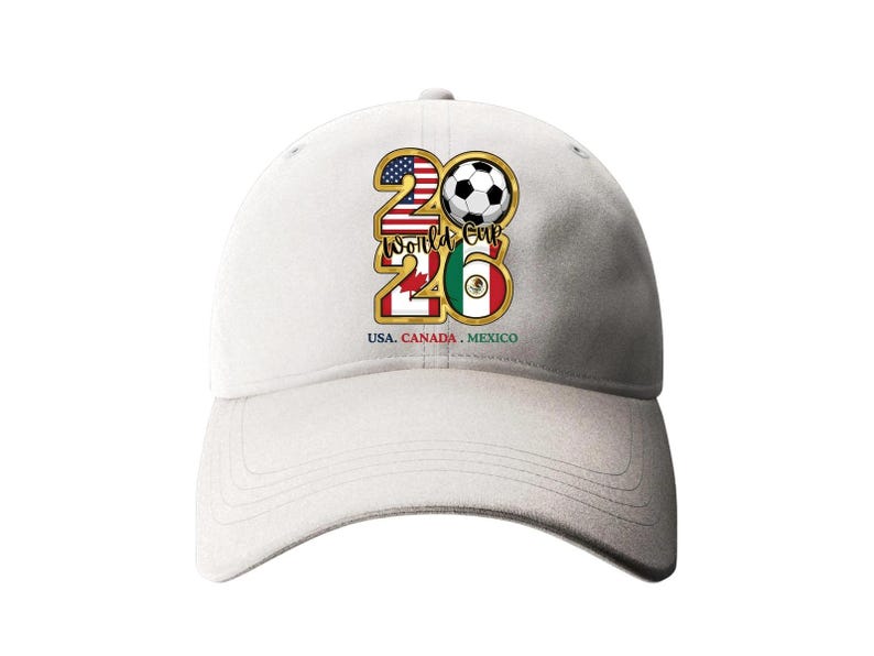May include: White baseball cap featuring a gold-framed "26" design with a soccer ball, the American and Mexican flags. The text "USA. CANADA. MEXICO" is printed below the design. A stylish accessory for soccer fans.