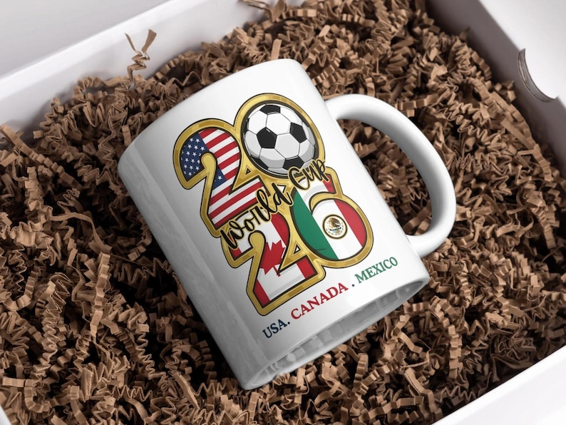 May include: A white ceramic mug with a black handle and the text "But First, Coffee" in a bold, black font. The mug is set against a blurred background, suggesting a cozy setting. The mug appears to be approximately 4 inches tall.
