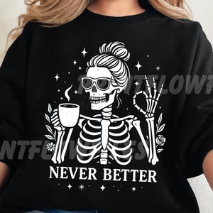 May include: Black sweatshirt with a white graphic of a skeleton wearing sunglasses and holding a coffee cup. The text "NEVER BETTER" is below the skeleton. The skeleton is giving the okay sign.