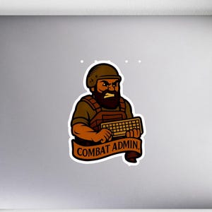 May include: A sticker featuring a cartoon illustration of a bearded man in military gear holding a keyboard. The sticker has a brown and orange color scheme with the words "COMBAT ADMIN" on a banner.