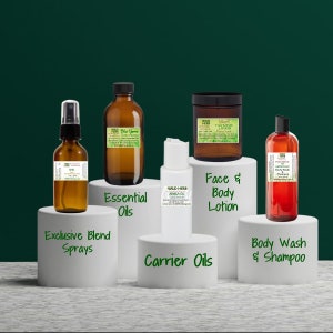 May include: A collection of amber glass bottles with labels, a white bottle with a label, and a red bottle with a label. The bottles are arranged on white platforms with text labels: "Essential Oils", "Carrier Oils", "Exclusive Blend Sprays", "Face & Body Lotion", and "Body Wash & Shampoo".
