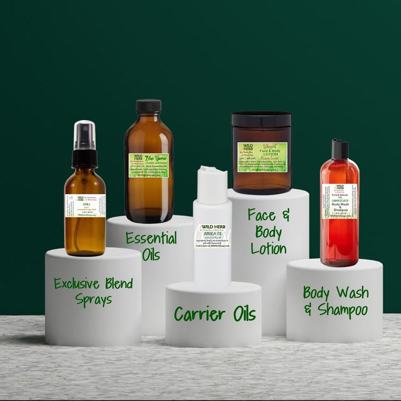 May include: A collection of amber glass bottles with labels, a white bottle with a label, and a red bottle with a label. The bottles are arranged on white platforms with text labels: "Essential Oils", "Carrier Oils", "Exclusive Blend Sprays", "Face & Body Lotion", and "Body Wash & Shampoo".