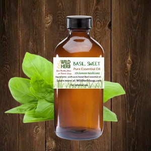 May include: A brown glass bottle with a black cap, labeled "WILD HERB BASIL, SWEET Pure Essential Oil (Ocimum basilicum)". The label also includes the text "Your Healthy Choice for Natural Living", "Ingredients: 100% pure Sweet Basil essential oil", "Learn more at: WildHerbSoap.com", and "For external use."