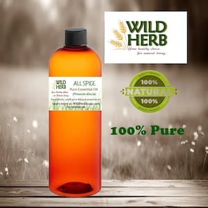 May include: A brown glass bottle with a clear label that reads "ALL SPICE Pure Essential Oil (Pimenta diocia)". The label also includes the text "Ingredients: 100% pure Allspice essential oil" and "Learn more at: WildHerbSoap.com". The bottle is sitting on a wooden surface with a blurred background of green foliage.