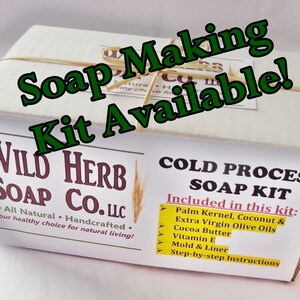 May include: A white box with the text "WILD HERB SOAP CO. LLC" and "All Natural - Handcrafted. Your healthy choice for natural living!" printed on it. The box is labeled "COLD PROCESS SOAP KIT" and lists the ingredients included in the kit: "Palm Kernel, Coconut & Extra Virgin Olive Oils, Cocoa Butter, Vitamin E, Mold & Liner, Step-by-step Instructions."