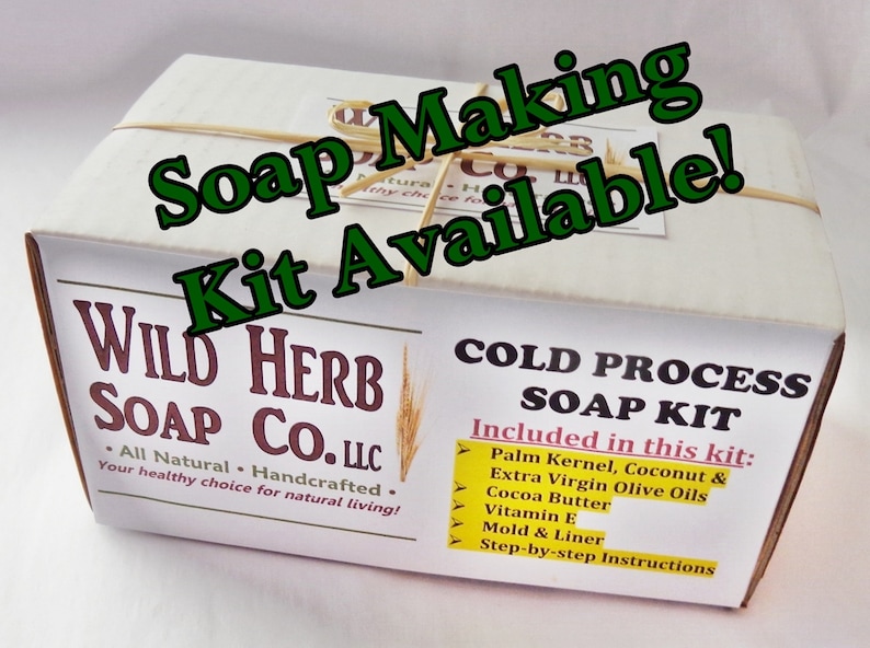 May include: A white box with the text "WILD HERB SOAP CO. LLC" and "All Natural - Handcrafted. Your healthy choice for natural living!" printed on it. The box is labeled "COLD PROCESS SOAP KIT" and lists the ingredients included in the kit: "Palm Kernel, Coconut & Extra Virgin Olive Oils, Cocoa Butter, Vitamin E, Mold & Liner, Step-by-step Instructions."