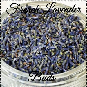 May include: Close-up of a glass jar filled with dried French lavender buds. The buds are a deep purple color and have a slightly green hue. The jar is labeled "French Lavender Buds".