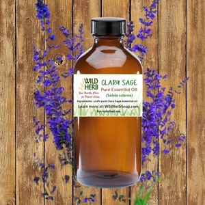 May include: A brown glass bottle with a label that reads "WILD CLARY SAGE HERB Pure Essential Oil (Salvia sclarea)". The label also includes the text "Your Healthy Choice for Natural Living" and "Ingredients: 100% pure Clary Sage essential oil. Learn more at: WildHerbSoap.com For external use."