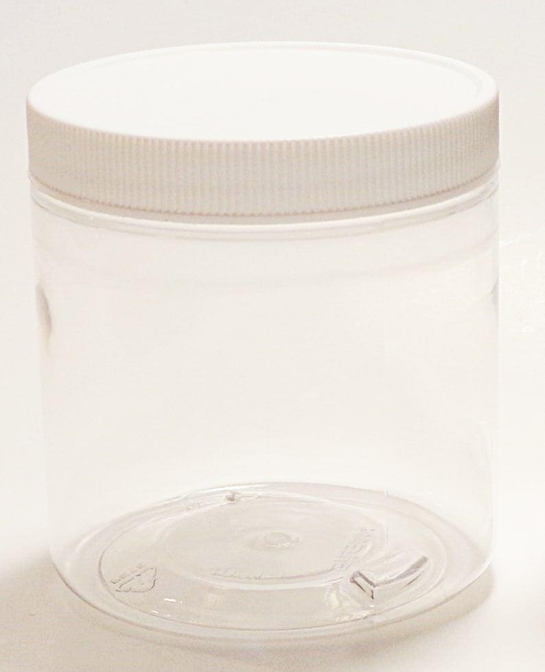 May include: A clear plastic jar with a white lid. The jar is empty and has a smooth, rounded bottom.