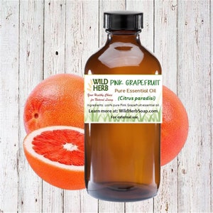 May include: A brown glass bottle with a label that reads "WILD HERB PINK GRAPEFRUIT Pure Essential Oil (Citrus paradisi)". The label also includes the text "Your Healthy Choice for Natural Living" and "Ingredients: 100% pure Pink Grapefruit essential oil. Learn more at: WildHerbSoap.com For external use."