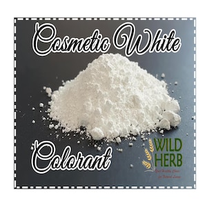 May include: White Cosmetic Colorant powder in a pile on a black surface. The text "Cosmetic White Colorant" is at the top of the image. The text "WILD HERB" is at the bottom of the image.