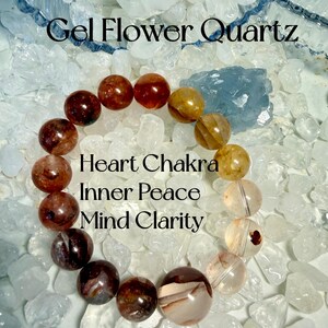 May include: A bracelet made of Gel Flower Quartz beads, in shades of brown, amber, and clear. The bracelet is displayed on a bed of clear quartz crystals, with text that reads "Gel Flower Quartz", "Heart Chakra", "Inner Peace", and "Mind Clarity".