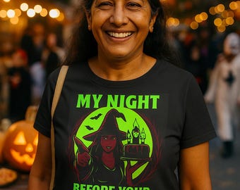 May include: A black crop top with the text "MY NIGHT BEFORE YOUR NIGHTMARE" in green. The graphic features a witch with a green background and a cake. The woman is smiling.