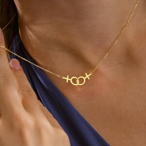 Close-up of model showcasing 925 sterling silver double Venus pendant.