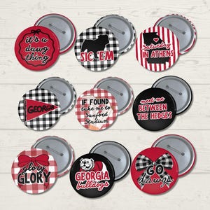 May include: A collection of nine circular pin-back buttons featuring red, white, and black designs. Text includes 'it's a dawg thing', 'SIC 'EM', 'SATURDAY IN ATHENS', 'GEORGIA', 'IF FOUND take me to Sanford Stadium', 'meet me BETWEEN THE HEDGES', 'glory GLORY', 'GEORGIA bulldogs', and 'GO dawgs'.