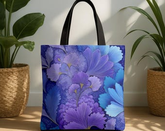 May include: A tote bag with a floral design in shades of blue and purple. The bag features black handles and a repeating pattern of stylized flowers and leaves. The bag is made of a durable fabric and is suitable for carrying various items.