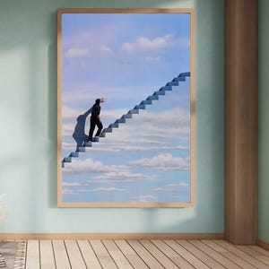 May include: A framed art print depicts a surreal scene of a person ascending a staircase that leads into a blue sky filled with clouds. The artwork is set in a room with light green walls and a wooden floor.